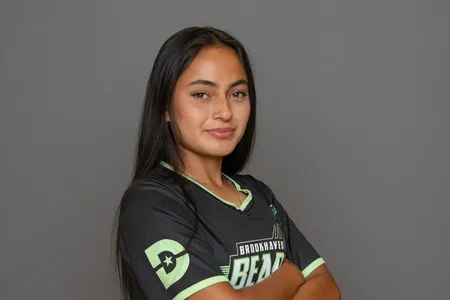 A Brookhaven women's soccer player stands with arms crossed.