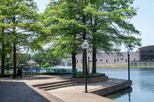 Cedar Valley Campus waterfront area with trees and a pedestrian walkway.