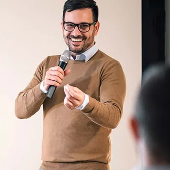 Alumni speaking into microphone