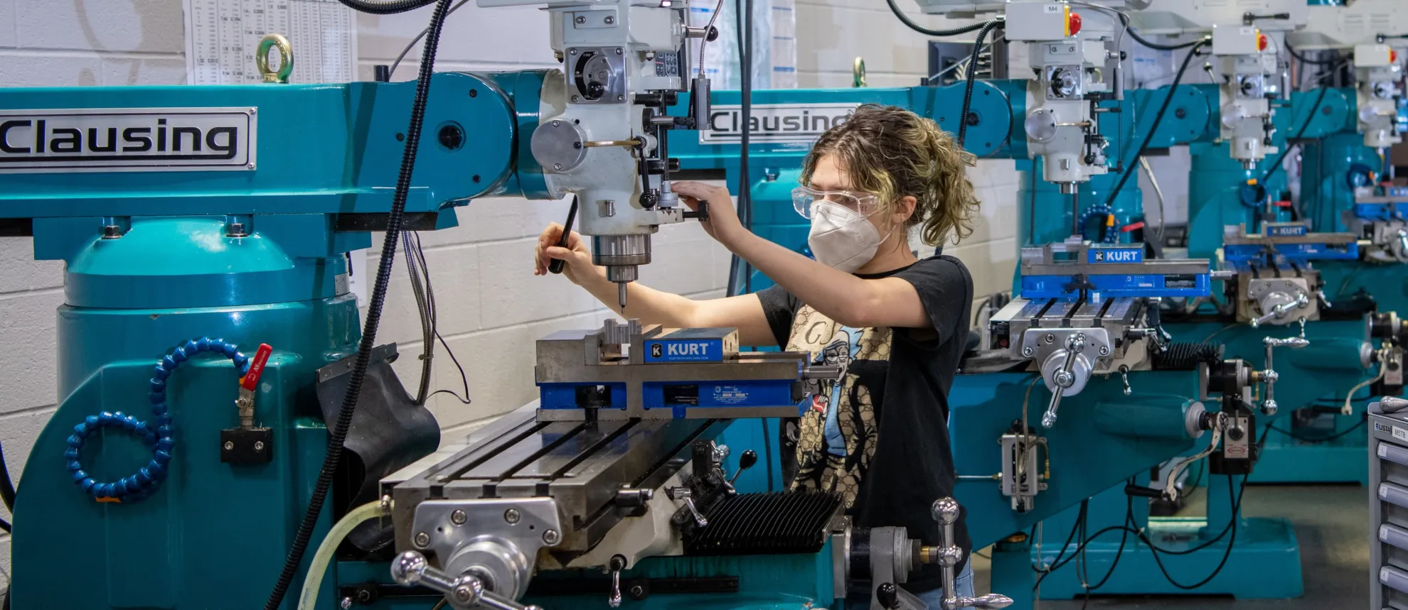 Person operating a machine in a workshop.