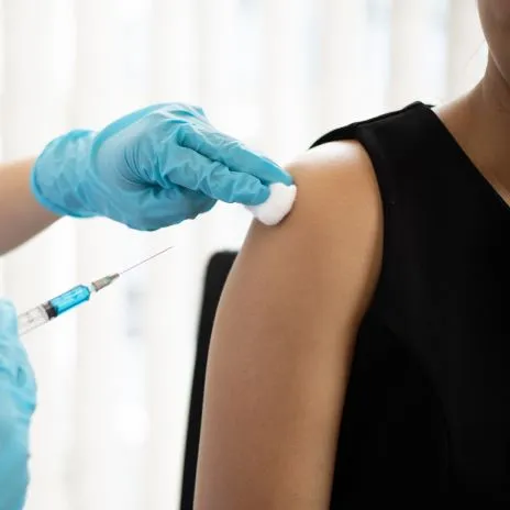 A person receives a vaccine in their upper arm