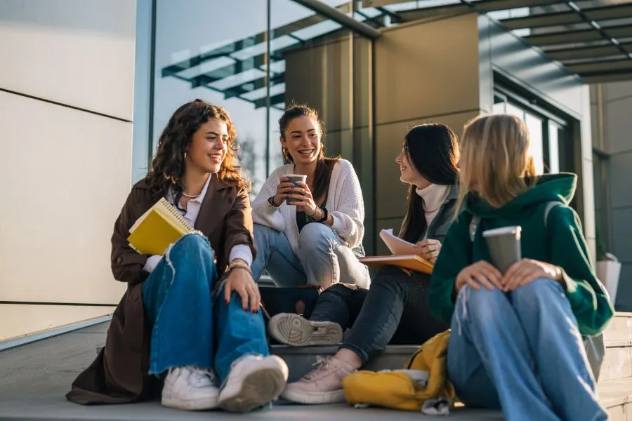 Students sit and talk on campus