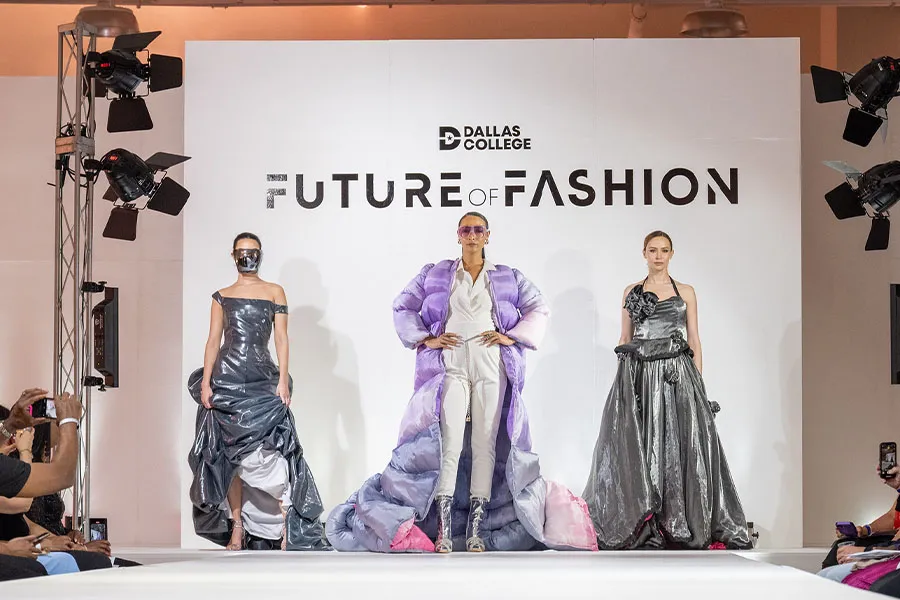 Models pose on a fashion show runway