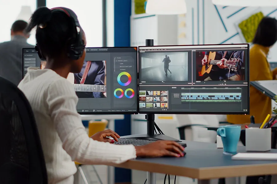 Videographer editing videos at a computer