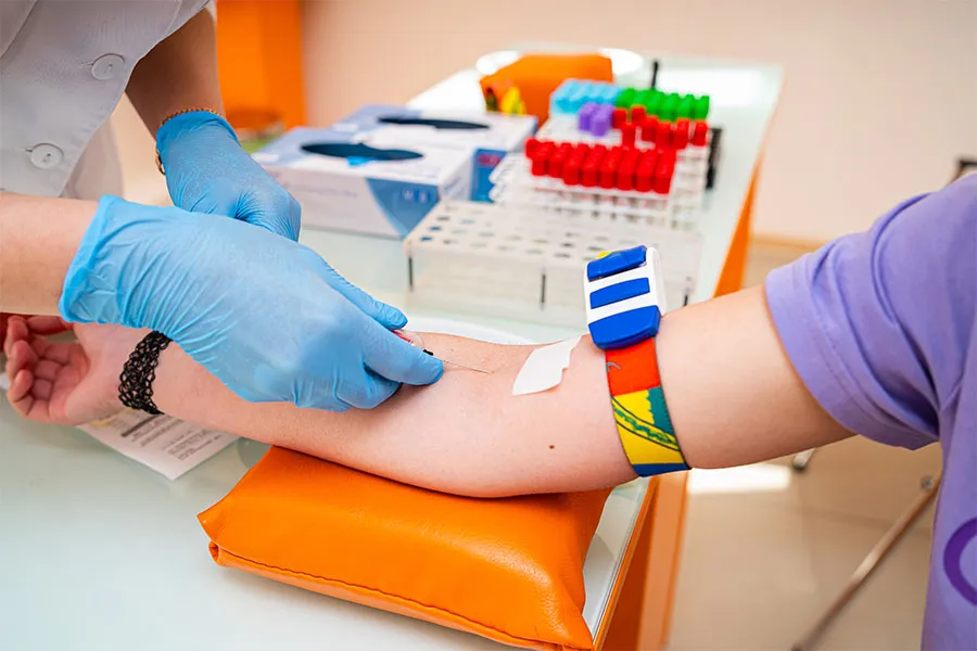 Tech inserting needle into a patient