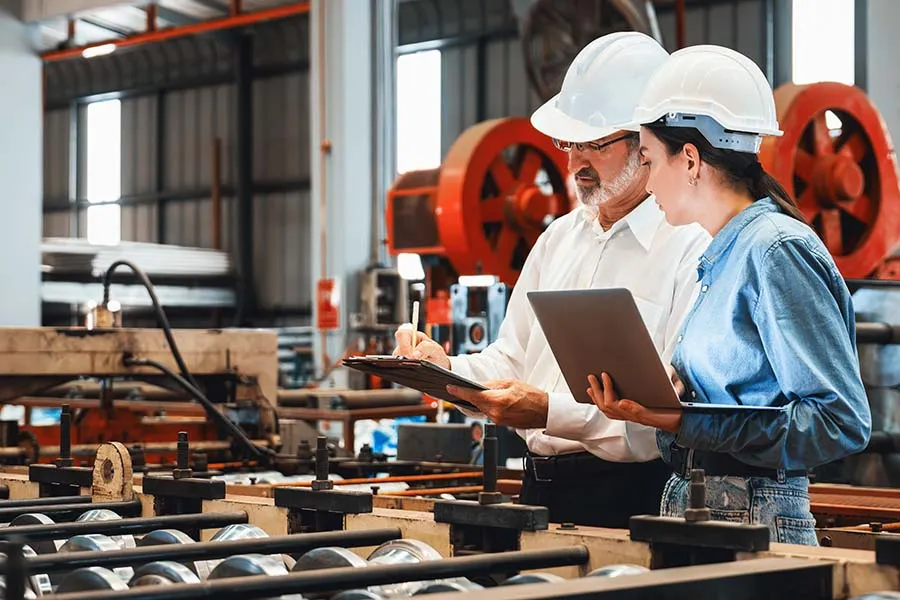 Engineers in a factory reviewing clipboards