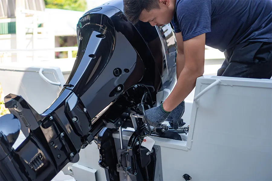 Man repairing a boat engine