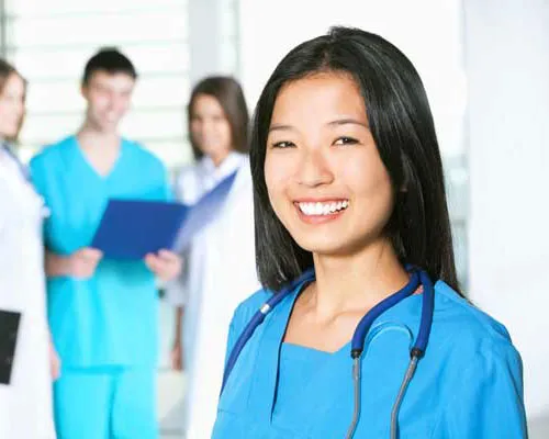 female smiling in scrubs