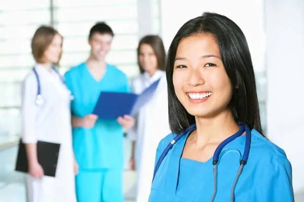 female smiling in scrubs