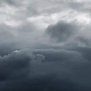 Dark, dense storm clouds fill the sky, exuding a moody and foreboding atmosphere, suggesting an impending storm