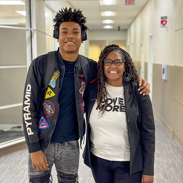 mother and son smiling and posing in the hallway