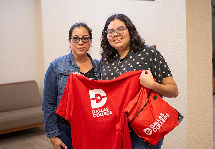 daughter and mom posing with red dallas college shirt and bag