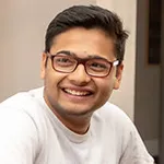 A closeup of a smiling student in a classroom