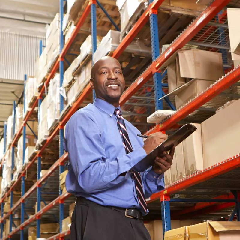A logistics manager doing an inventory check at warehouse