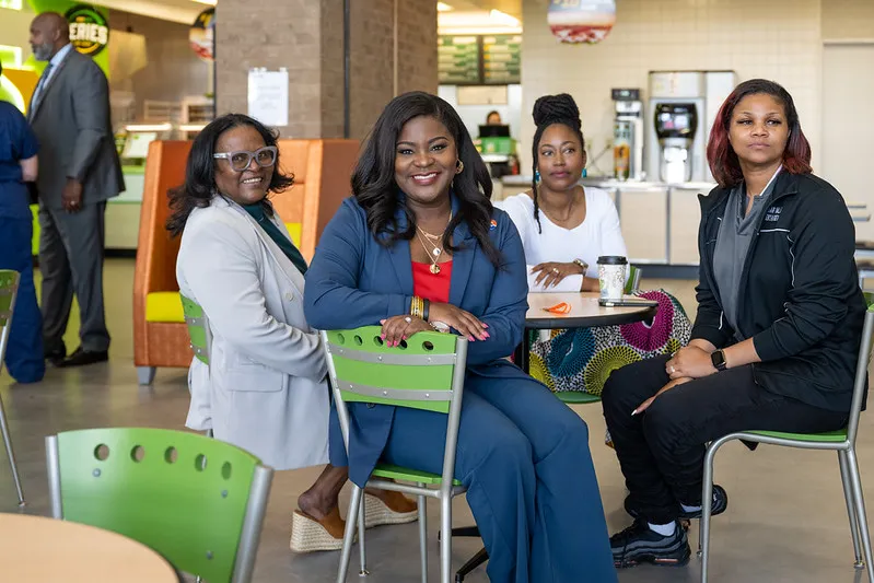 Employees sit around a table at Cedar Valley cafeteria