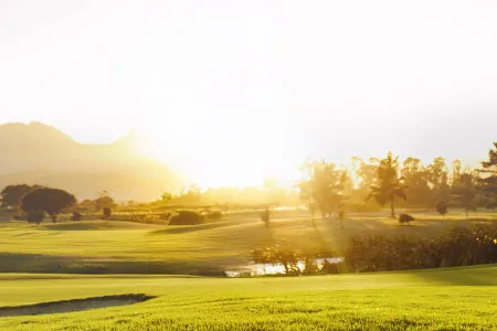 a golf course at sunrise or sunset