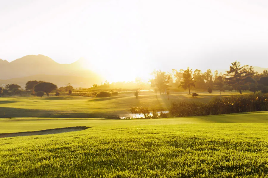 a golf course at sunrise or sunset