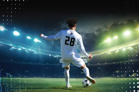 a soccer player prepares to kick a ball in a stadium