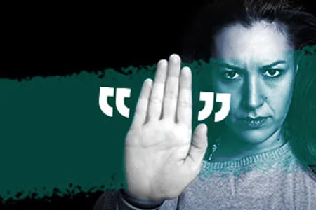 A woman holding her hand up to say "no" or "stop"