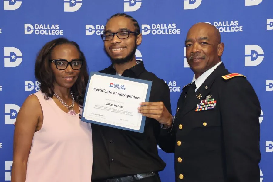 An MCS student receives an award and poses for a photo
