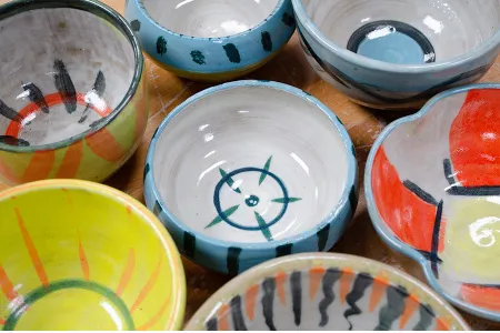 close-up of several colorfully painted ceramic bowls