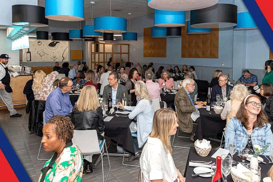 groups of people sitting at small tables at the Culinary, Pastry and Hospitality Center dining room