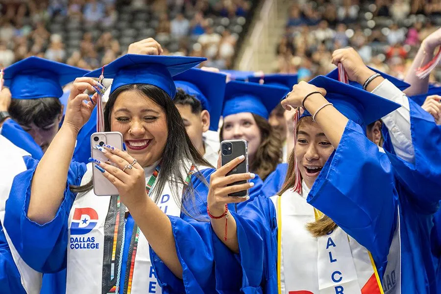 Graduates take selfies while they move their tassles