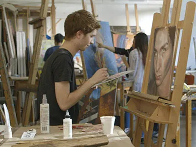 Student painting a portrait