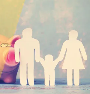 A paper cutout shows a father, child and mother holding hands