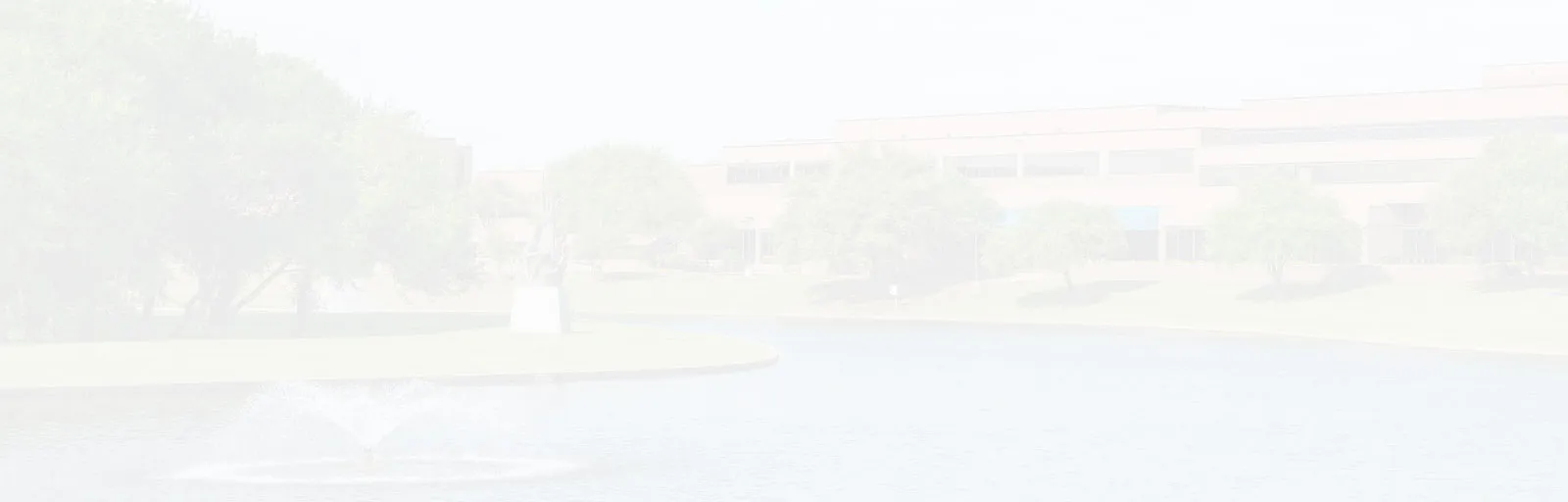 A faded photo of the North Lake campus at a distance