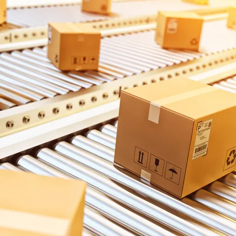 A conveyer belt is full of boxes and packages