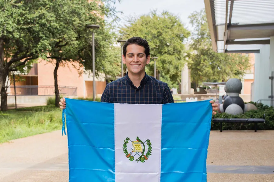 Daniel Juarez holding up Guatemalan flag.