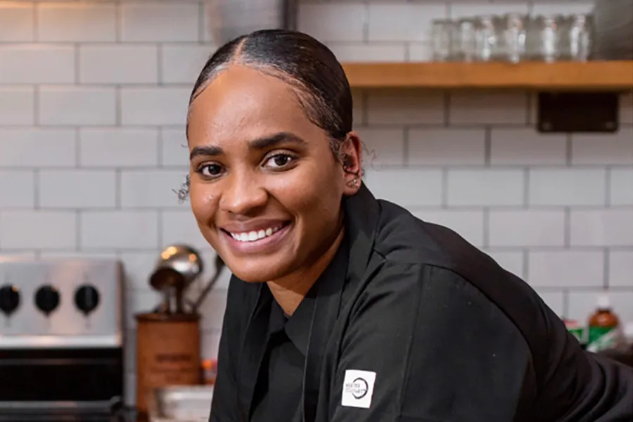 Temika McCaskill leaning on kitchen counter.