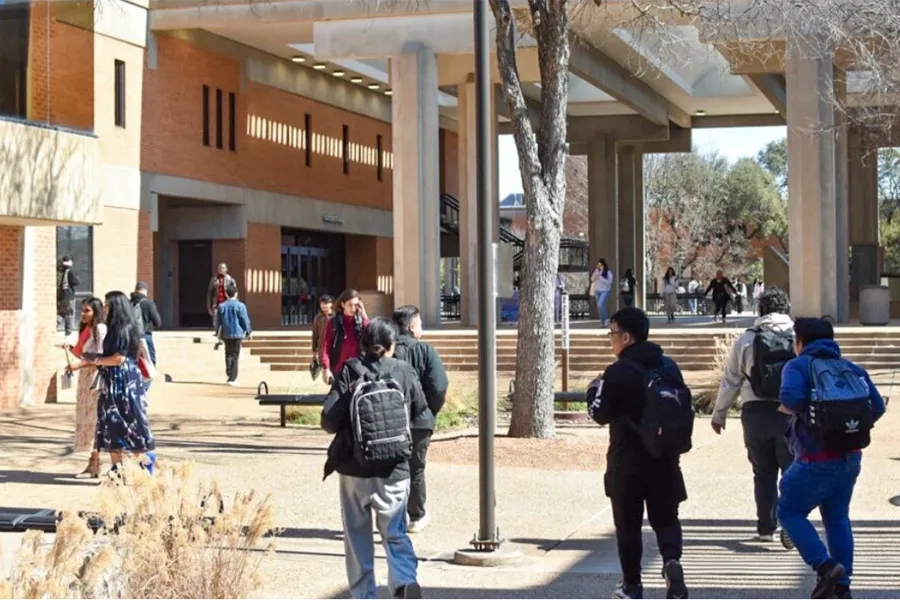 Students walk through a Dallas College campus courtyard between academic buildings as they make their way to classes and campus activities.