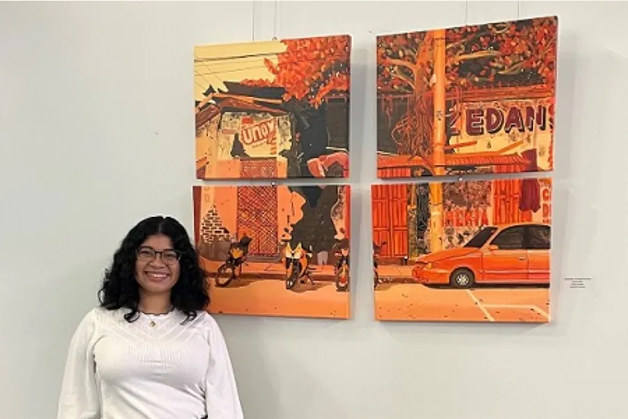 Soraya Burgos stands beside her four-panel painting, 
