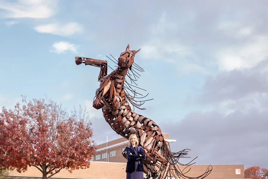 Christa Slejko with horse sculpture.