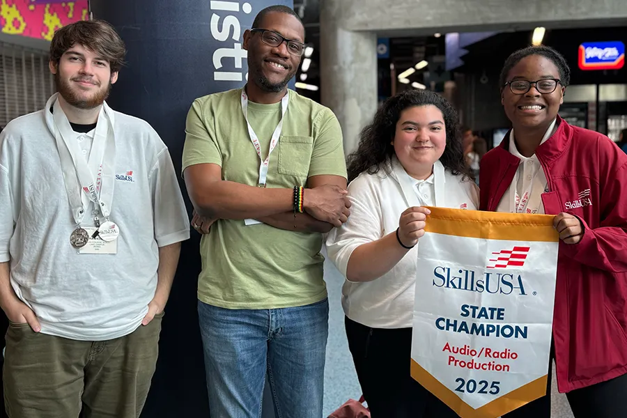 Skills USA Students pose with banner