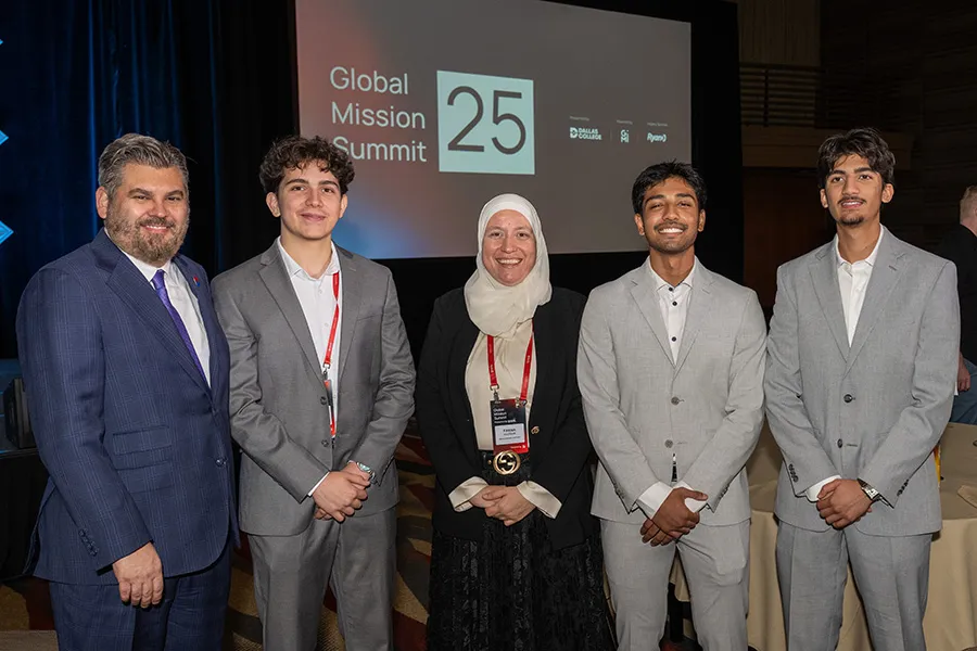 Three attendees at Global Mission Summit with Dr. Lonon