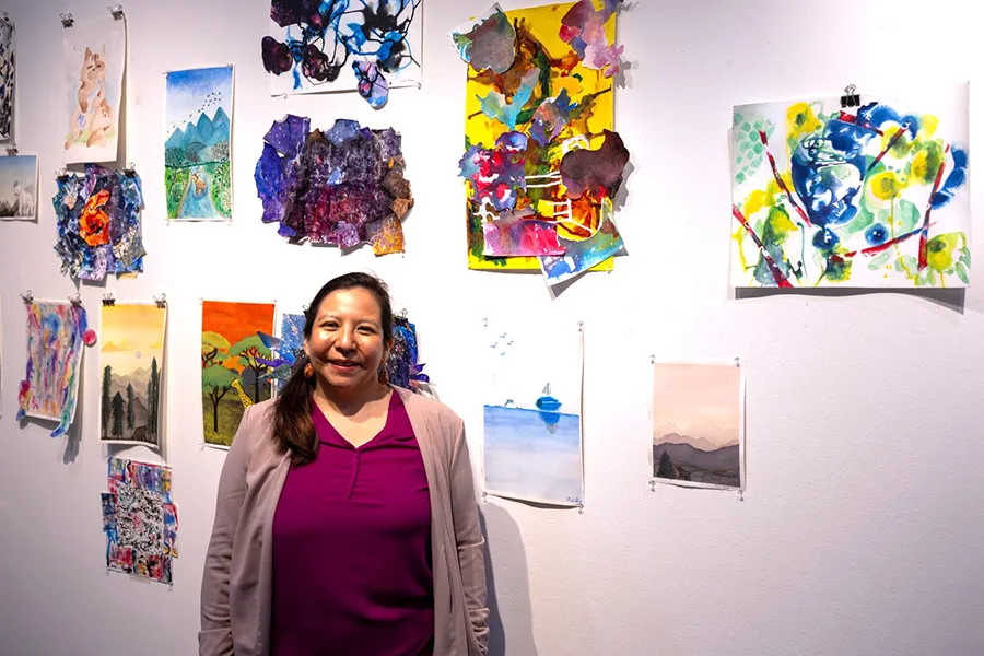 Tina Medina standing in art gallery