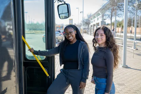 Two students about to board a DART bus