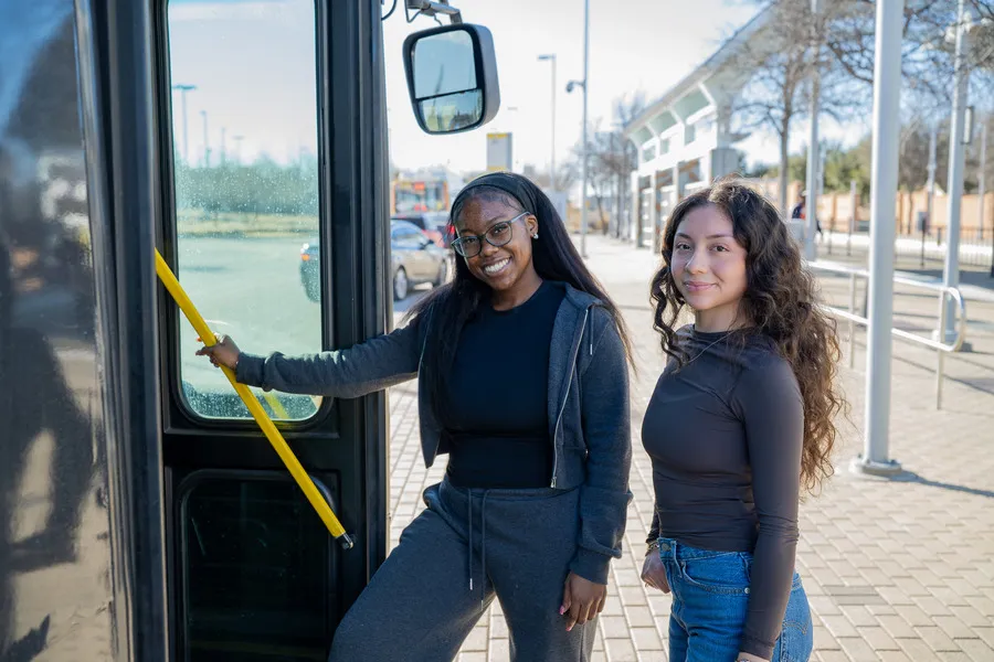 Two students about to board a DART bus