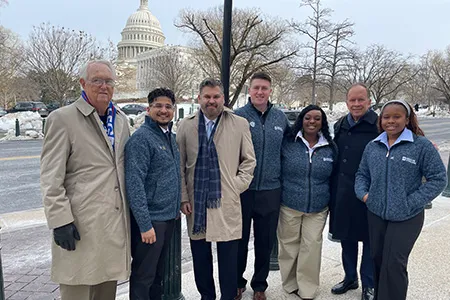 Dallas College students and leaders stand in front of the U.S. Capitol