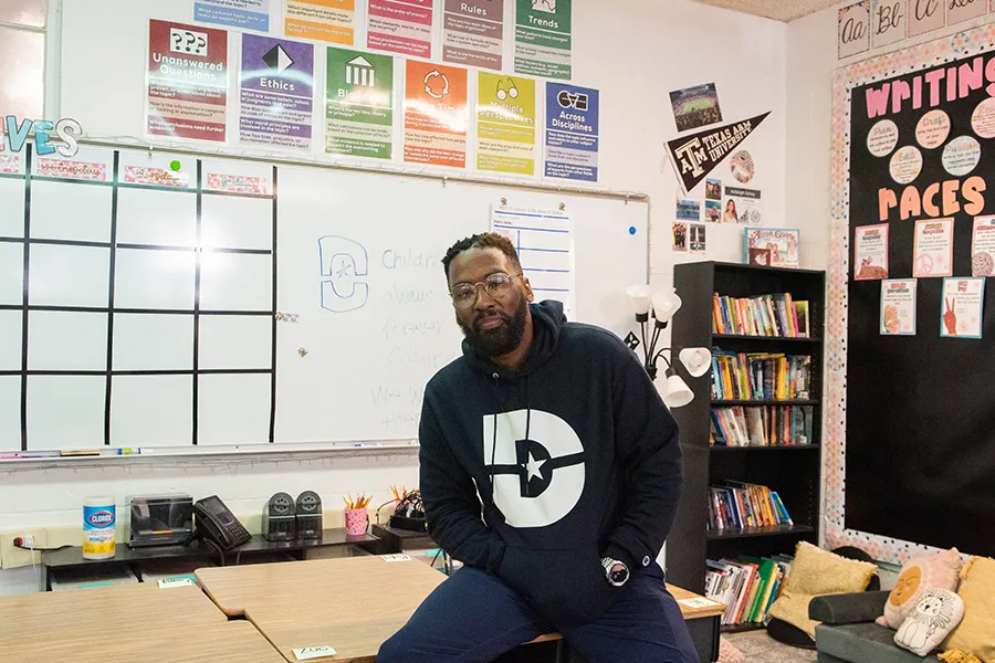 Dallas College student Darius Moss is pictured at the front of a classroom.