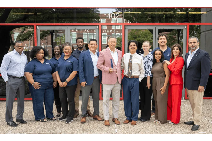 HR team accepting award outside of a building