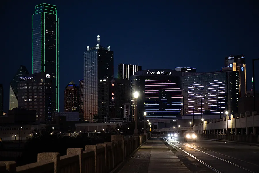 The Dallas College logo is displayed on the side of the Omni hotel in downtown Dallas