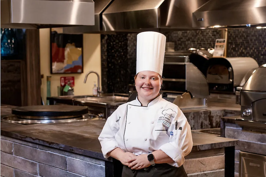 Chef Rosemary Pate posing in a professional kitchen.