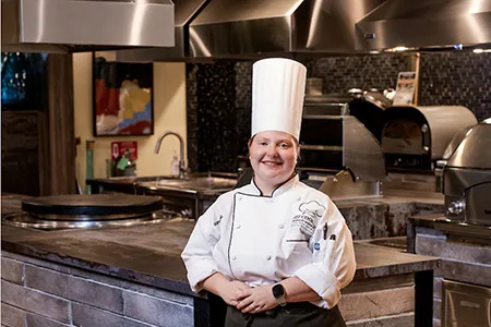 Chef Rosemary Pate posing in a professional kitchen.