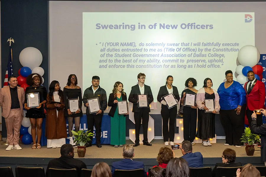 A group of SGA officers stand on stage as they are sworn in.