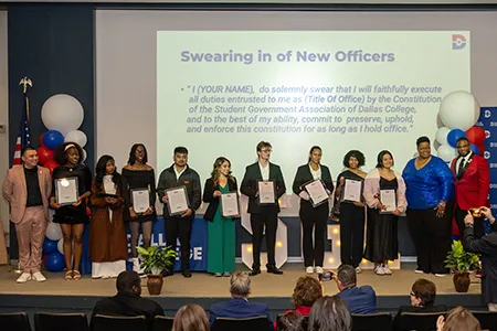 A group of SGA officers stand on stage as they are sworn in.