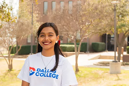 Dallas College student Subah Saiara Ahmed is pictured outdoors wearing a Dallas College shirt.